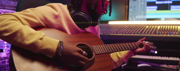 African American Man Playing Guitar in Recording Studio