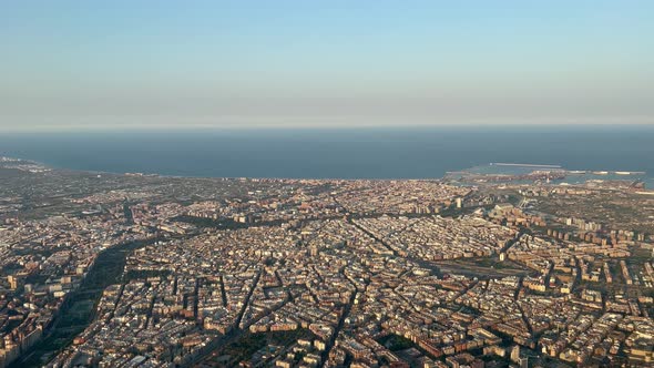 Aerial view, pilot point of view of Valencia city, Spain, in a hot summer day with some haze and unc