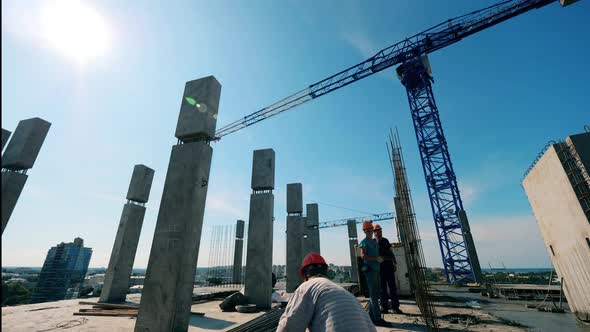 Timelapse of Construction Workers and a Crane Build a House.