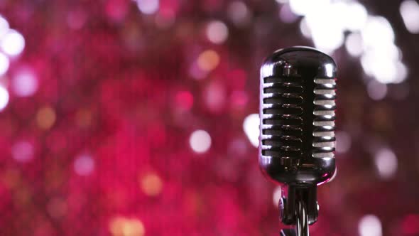 Vintage Microphone on Red Shiny Background on Stage in Nightclub