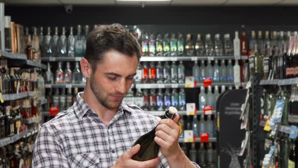 Young Man Smiling To the Camera While Choosing Wine