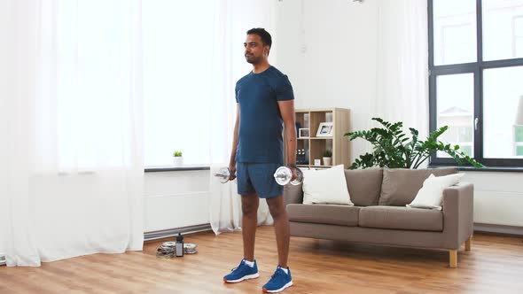 Indian Man Exercising with Dumbbells at Home