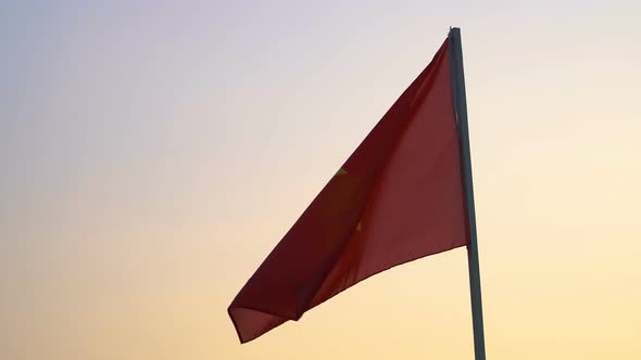 Vietnam flag waving over sunset sky.