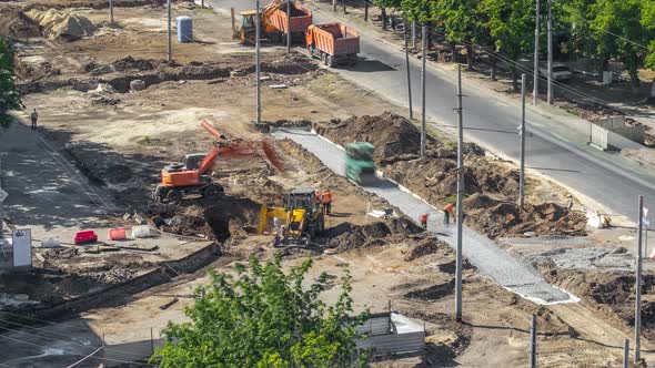 Green Vibration Roller Compactor Rolls on a Stones at Road Construction and Repairing Timelapse