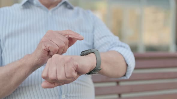 Close Up of Old Man Using Smart Watch