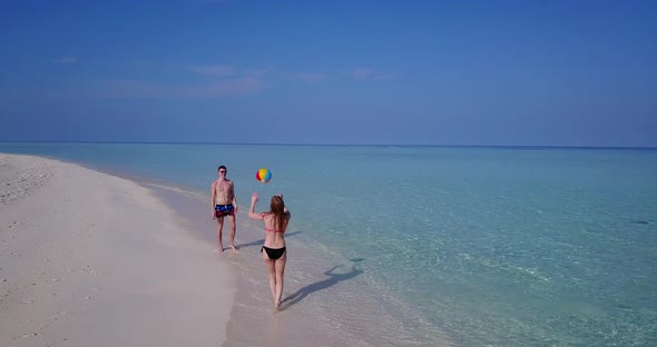 Romantic lady and man on romantic honeymoon enjoy life on beach on clean white sand background 