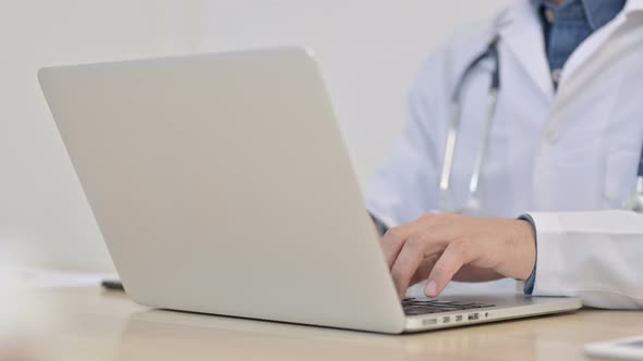 Doctor Typing on Laptop 