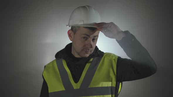 Portrait Industrial Engineers in Hard Hat on a Black Background in the Spotlight.