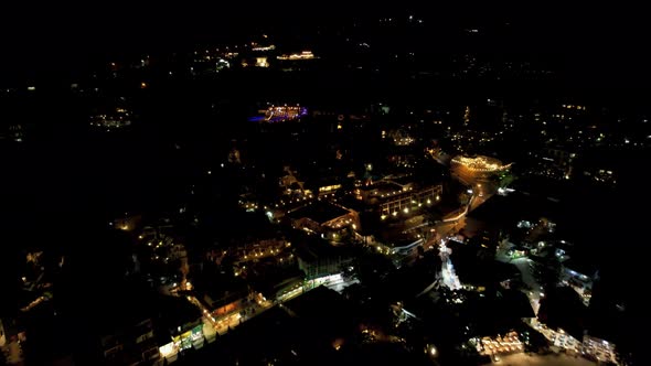 View of Night City with Lights and a Swimming Pool