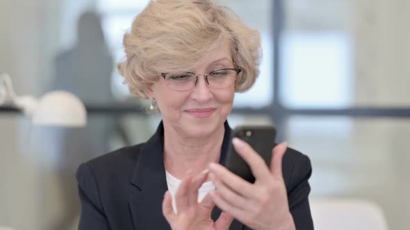 Portrait of Old Businesswoman Using Smartphone