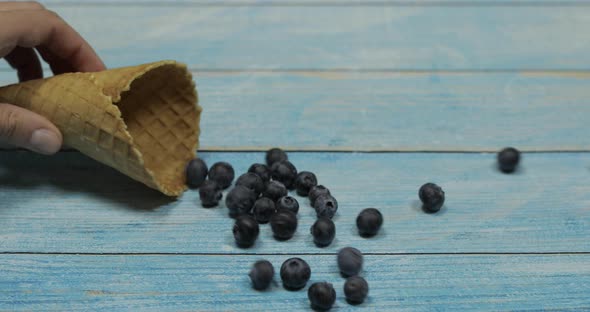 Berry Ice Cream. Berries of Blueberries in a Waffle on a Blue Wooden Background