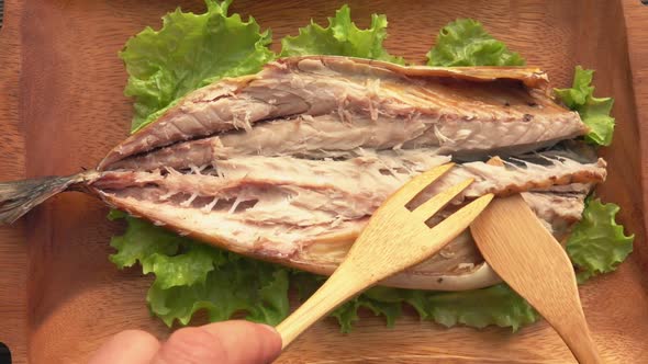 The Bamboo Fork is Taking a Spine From the Grilled White Mackerel Fish