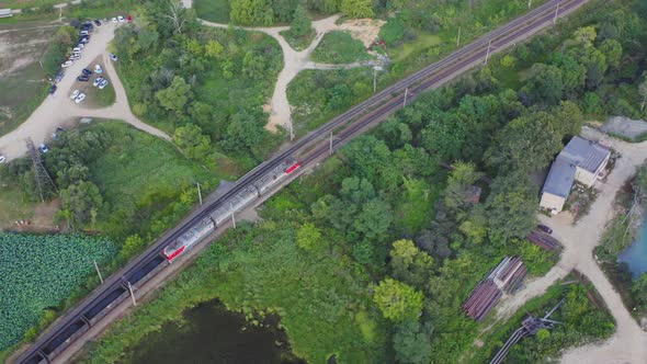 Aerial View of Freight Train with Coal Moving By Rail Among Green Nature