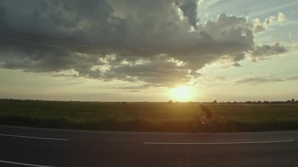 A Cyclist is Riding Fast on the Highway