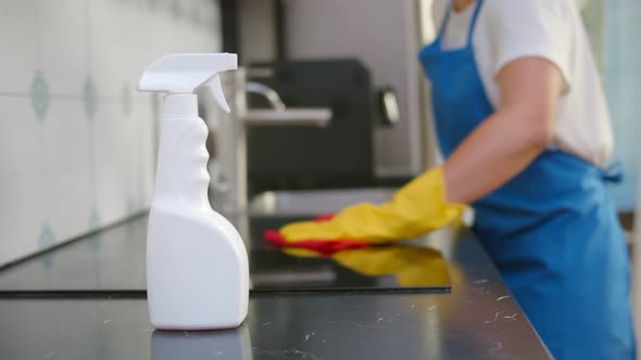 Close Up of Woman s in Gloves Washing and Cleaning Counter Top in Kitchen with Rag