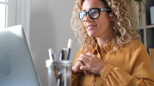 Smiling businesswoman using laptop at home office