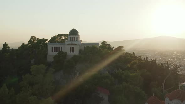 Aerial View of National Observatory of Athens on Hill During Golden Hour Sunset Light 