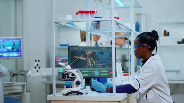 African Laboratory Scientist Working at Lab with Test Tubes