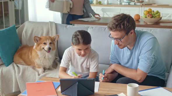 Young Father Helping His Cute Daughter Schoolgirl with Research