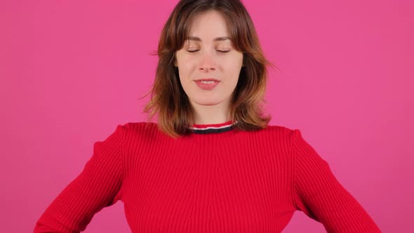 Close Up of an Young Woman Making a Thumb Up Gesture on a Pink Background