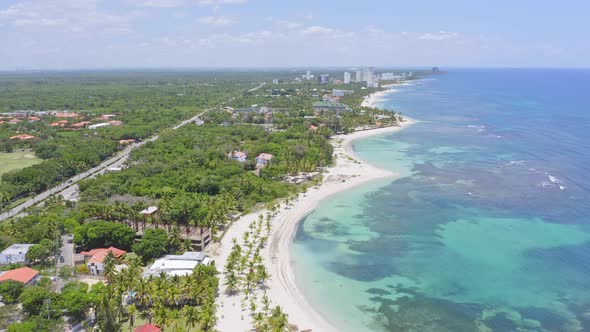 Aerial backwards shot of beautiful Juan Dolio Beach with coral reefs underwater during sunlight - Tr