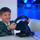Happy Excited Little Boy Playing Videogame with Racing Wheel - VideoHive Item for Sale