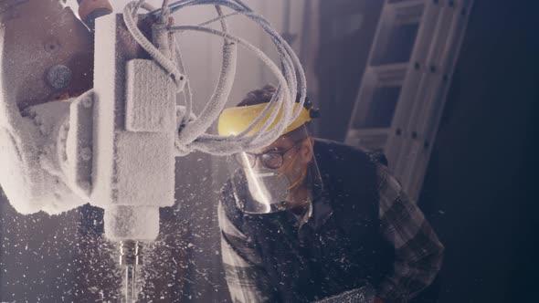 Male Employee Watching Process of Cutting Plastic