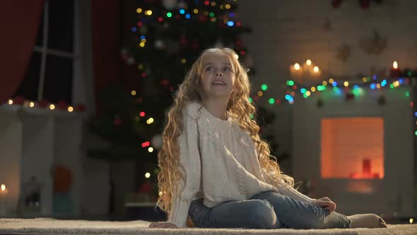 Girl Sitting on Floor in Room Decorated for X-Mas, Waiting Santa, Holiday Magic