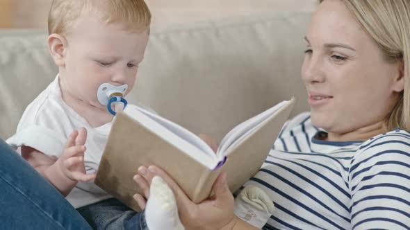 Young Mother Reading Story to Baby