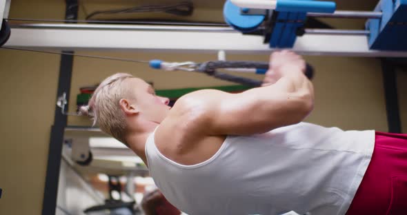 Closeup Vertical Video of a Strong Man Bodybuilder Pumping Triceps at Gym