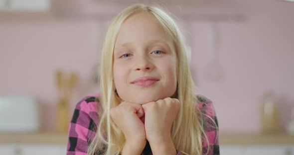 Portrait of Blonde Long Hair School Girl Smiling and Laughing Looking at Camera. Positive Child in