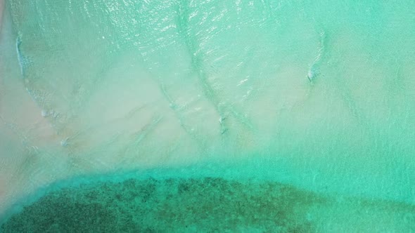 Aerial seascape of perfect resort beach holiday by blue lagoon and white sandy background of a dayou