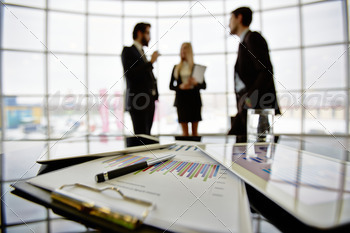 rkplace on background of three business partners discussing ideas