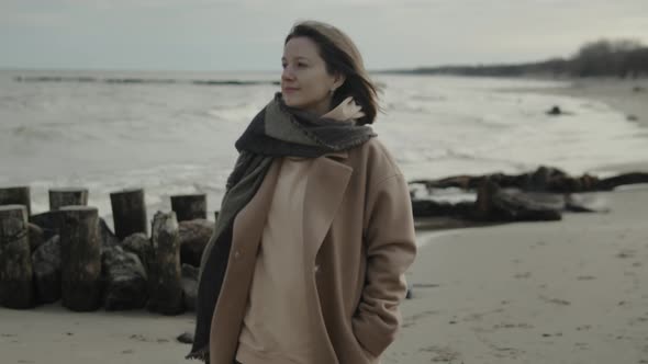 Woman Walking Along The Beach