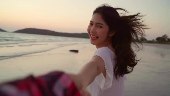 Young Asian couple running and playing on beach, sweet couple have romantic time.