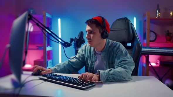 Young Hipster Man Wearing Headphones Playing Computer Game Neon Fashion Room Loser