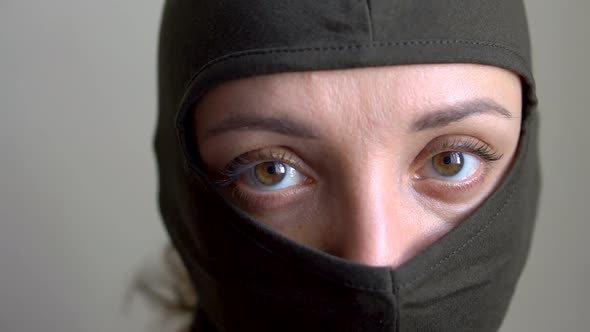 Female Portrait of Young Girl Wearing Khaki Balaclava Only Eyes are Visible Mandatory Conscription