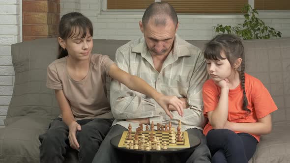 Parent with Children Relaxation with Chess Board