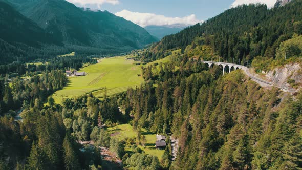 Landwasser Viaduct in Swiss Alps in Summer Aerial View on Green Mountain Valley