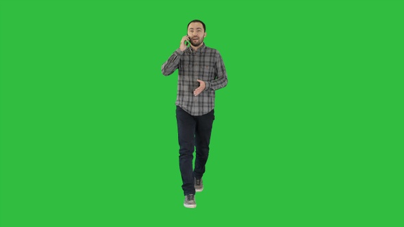 Young man talking on mobilephone on a Green Screen, Chroma Key