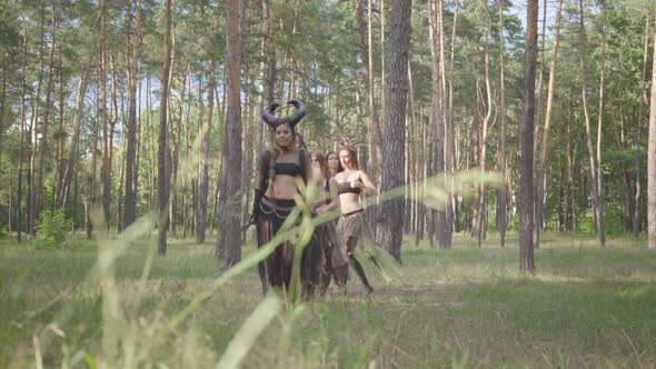 Young Women in Theatrical Costumes of Forest Nymphs Dancing in Forest Showing Perfomance or Making