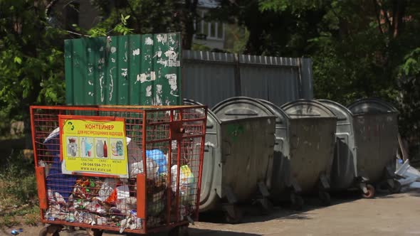 A Man Throws Garbage in the Trash. Kyiv. Ukraine
