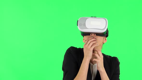 Happy Young Woman with Virtual Reality Headset or 3d Glasses. Green Screen