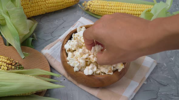 Tasty Traditional Popcorn and Corn Cobs on Grey Background