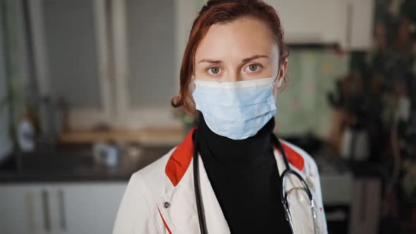 Young Doctor or Nurse with Home Visit Looks at You