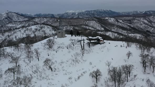 ski lift taking skiers to the snow covered mountain peak in nozawa onsen ski resort in nagano japan,