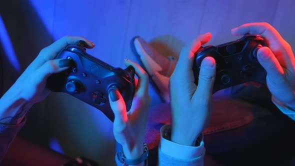 Controller in the Hands of Gamers. Young Couple Man with a Girl Are Playing