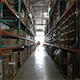 Slow Dolly Shot Down Warehouse Aisle - VideoHive Item for Sale