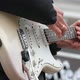A Man Plays on Electric Guitar Strings with a White Body - VideoHive Item for Sale