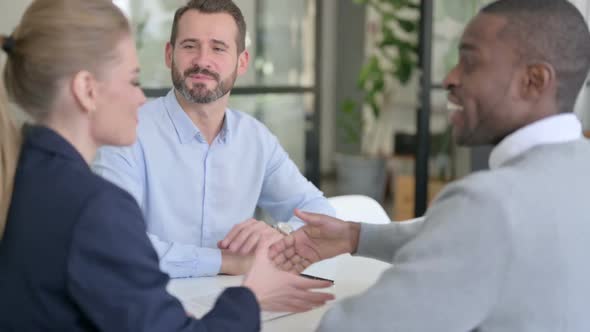 Successful Mixed Race Business People Shaking Hands in Office